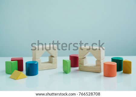 Colorful wooden building blocks on white background