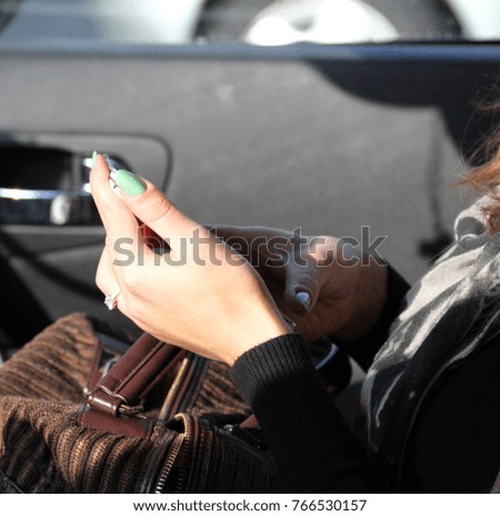 Woman using a smartphone in a car