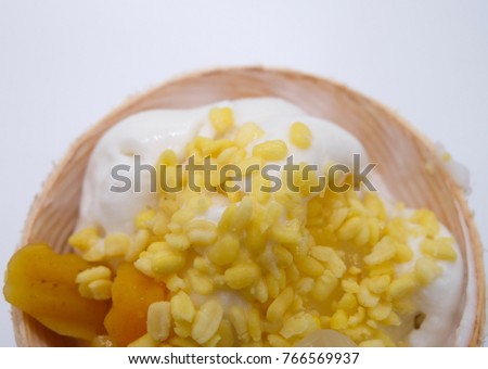 Top view and close-up of Coconut Ice Cream with soybean, nuts , Thai potato in syrup, Nipa Palm is on white background