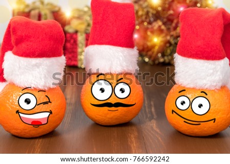 Christmas background with tangerines in Santa Claus hat. Funny characters.