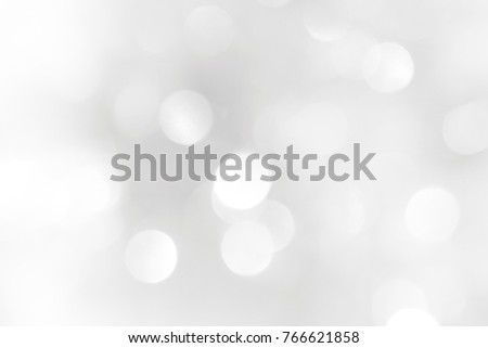 Brilliant background for a Christmas greeting card. Circles small and large silvery and white with blurred edges.