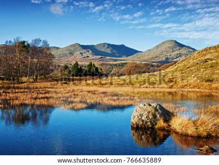 The stillness of Kelly Hall Tarn, with the old man of Coniston gracing the background