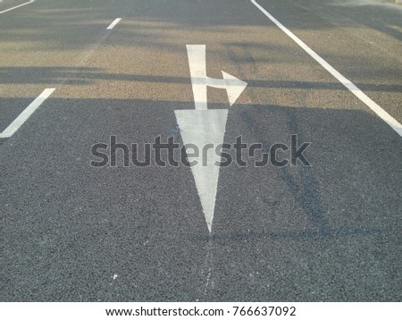 draft and real white color of arrow sign, go forward or turn left direction on the road with singlight and shadow