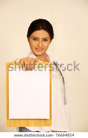Medical sign. Young woman doctor / nurse showing empty blank clipboard sign with copy space for text. indian asian caucasian female model isolated over white background.