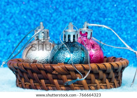 Christmas ball colorful in wood basket on the soft cloth with background silver foil blue,For decorations background festive happy new year,Space for text background