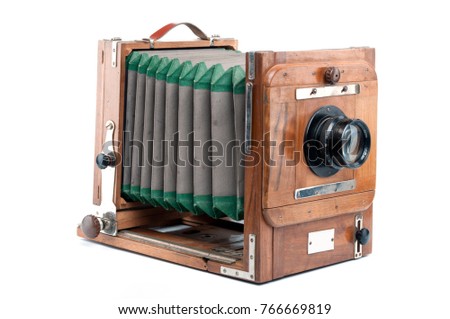 An image of old wooden large format photocamera on white