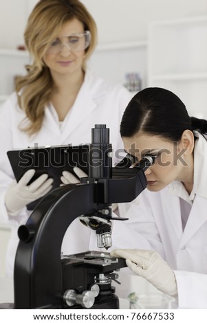 Two scientists conducting an experiment in a lab