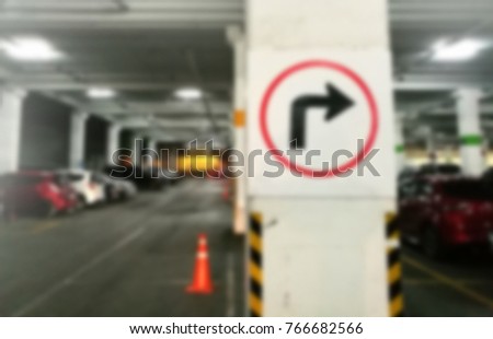blur image of turn right arrow traffic sign in car parking