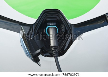 Close up power supply connected to electric car Royalty-Free Stock Photo #766703971