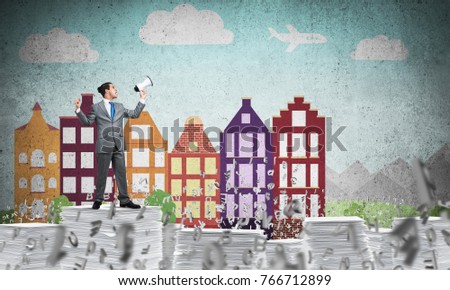 Businessman in suit standing among flying letters with speaker in hand with sketched cityscape view on background. Mixed media.