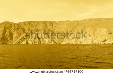 Gold colored Sea of Oman. Middle Ages style photo. Arabian peninsula