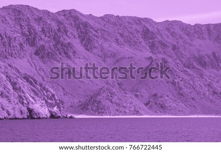 Purple colored Sea of Oman artistic view . Middle Ages style photo. Arabian peninsula