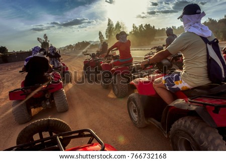 two lines of  tourist on ATV in Egypt desert in safety hats Royalty-Free Stock Photo #766732168