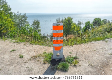 Close up of Orange traffic pole on ground for safety Area in Canada