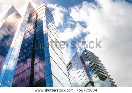 Modern High-rise Glass Buildings with Steel Frames Reflecting the Sky