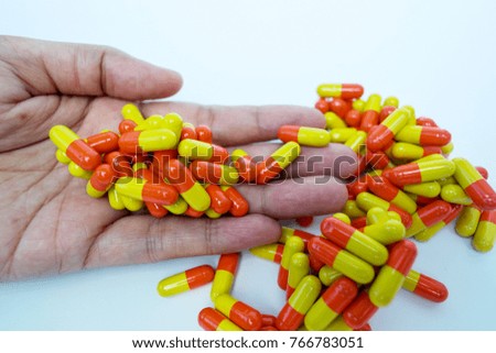 The medicines capsule pill in hand on white background