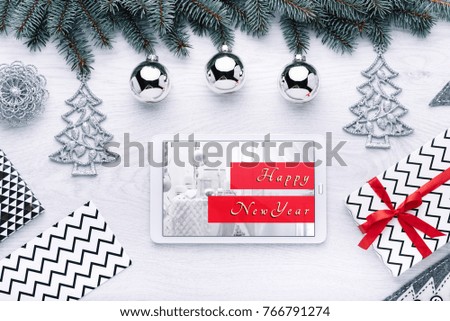 Beautiful celebratory Christmas background. New Year's holidays. Christmas holidays. Beautiful Christmas decorations on the wooden background. Digital technology. Tablet copy space text 