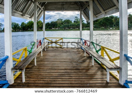 landscape photo of wooden bench on the lake