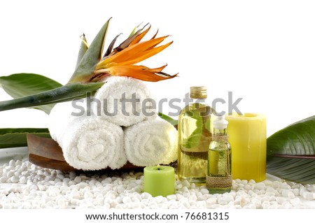 wooden bowl of towel and spring flower with massage oil on white pebble Royalty-Free Stock Photo #76681315