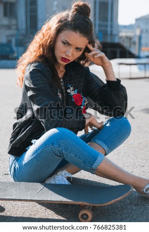 summer portrait of young woman posing in urban, girl with skate board in town