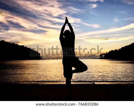 young man play yoga on phuket sand beach thailand when sunset with beautiful sky