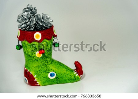 New Year's green boot with silver cones and bells on a white background for greeting card design