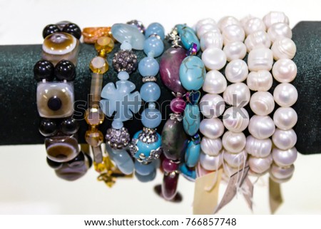 Women's bracelets from semiprecious stones. Showcase in the shop.