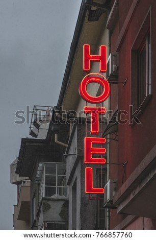 Small cheap hotel. Text Hotel on facade. Hotel in the city.