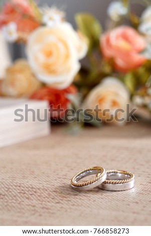 Two wedding rings on table decorate with flower. Engagement. Wedding day, Valentine's concept. Copy space.