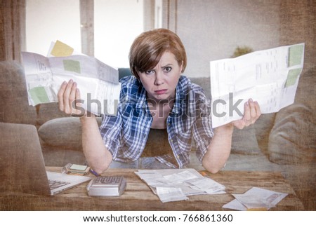 young sad worried and desperate woman banking and accounting home monthly and credit card expenses with computer laptop doing paperwork in living cost stress and paying bills grunge edit