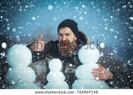 new year christmas snow concept Winter holiday vacation and xmas party celebration. New year guy on blue sky with snow figure. Christmas man with long beard. Snowman family made of white snow Santa