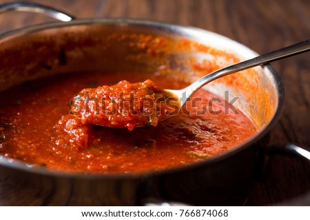 Tomato Sauce with Spoon in Metal Pan Royalty-Free Stock Photo #766874068