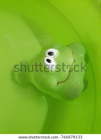 Green prawn toy soak in the water 