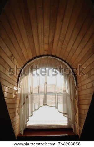 Ancient wooden window with curtains