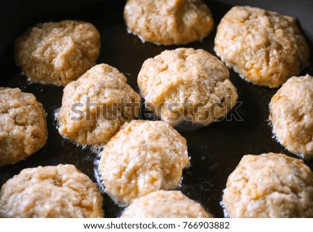 Meat cutlets during frying process in the pan