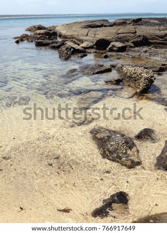 coastal rocky sand sea shore sky outdoor clear water
