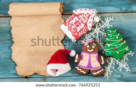 Christmas cookies with vintage paper roll on wooden table. 