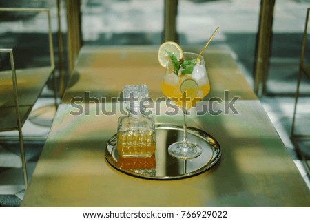 Lemonade iced tea decorated with lemon slices and lime slice.