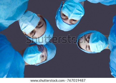 Team surgeon at work in operating room.