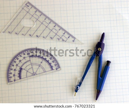 The compass ruler and protractor on the graph paper