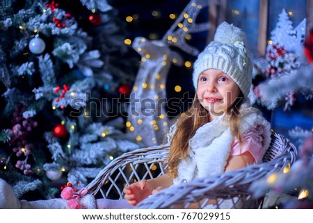 A girl in a hat in a New Year's interior