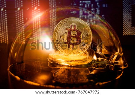 Bitcoin in a soap bubble on video card background. Dangers and risks of investing to bitcoin. Speculation Royalty-Free Stock Photo #767047972