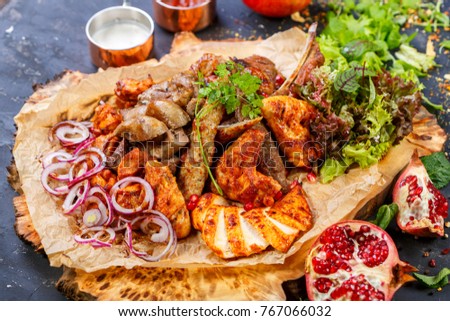 Oriental traditional cuisine. Meat plate with onion rings and sauce. Asian oriental restaurant menu. Royalty-Free Stock Photo #767066032