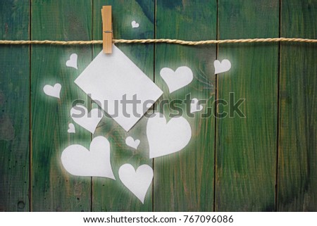 Paper Heart and Card Hanging on Clothesline on Old Wood Background. Valentines Day 