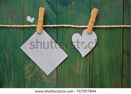 Paper Heart and Card Hanging on Clothesline on Old Shabby Wood Background