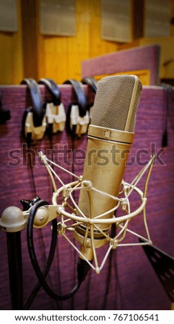 microphone stand with wire, with headphones on the background in the recording Studio