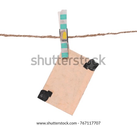 Old picture frame hanging on clothesline isolated on white background.