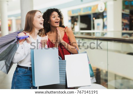 Girls are shopping at the mall. Sale in black Friday. Girls are shopping on a black Friday. They are thrilled with shopping.