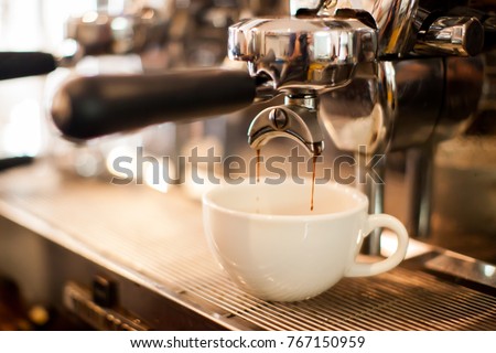 coffee extraction from professional coffee machine with bottomless filter Royalty-Free Stock Photo #767150959