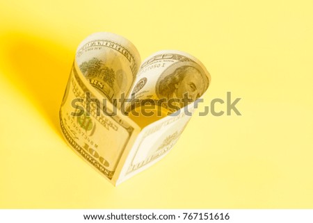 Dollar US bills in heart shape 